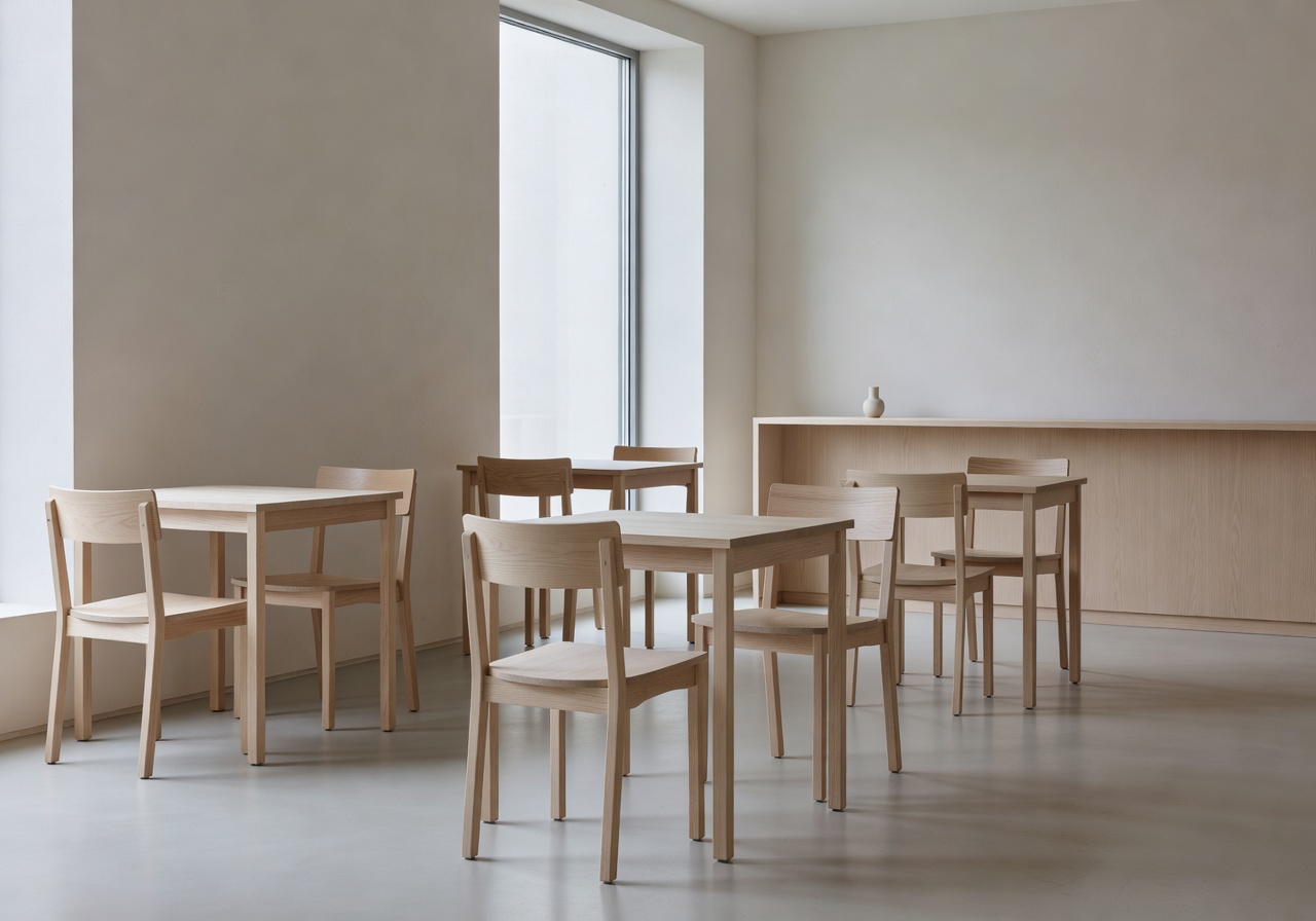 Modern Nordic café seating area with wooden chairs and minimal design